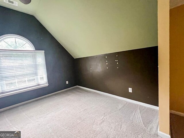 bonus room featuring carpet flooring and vaulted ceiling