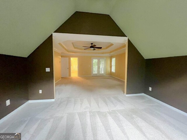 additional living space featuring light colored carpet and ceiling fan