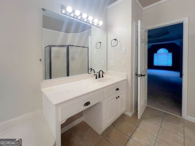 bathroom featuring tile patterned flooring, crown molding, and vanity