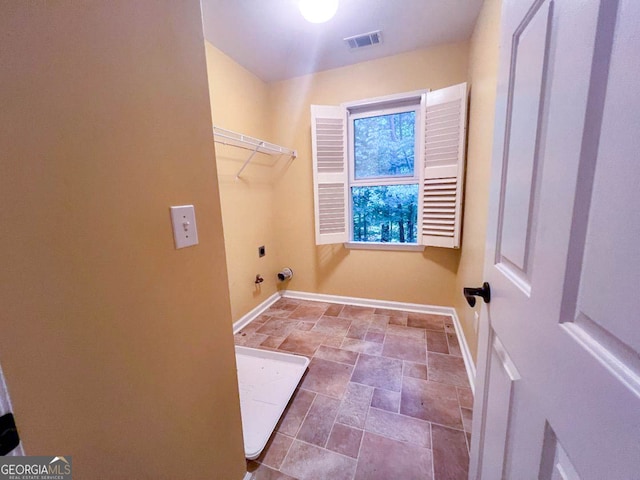 clothes washing area featuring hookup for an electric dryer, hookup for a gas dryer, and tile patterned floors