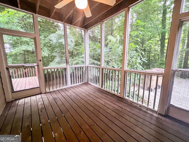 unfurnished sunroom with plenty of natural light and ceiling fan