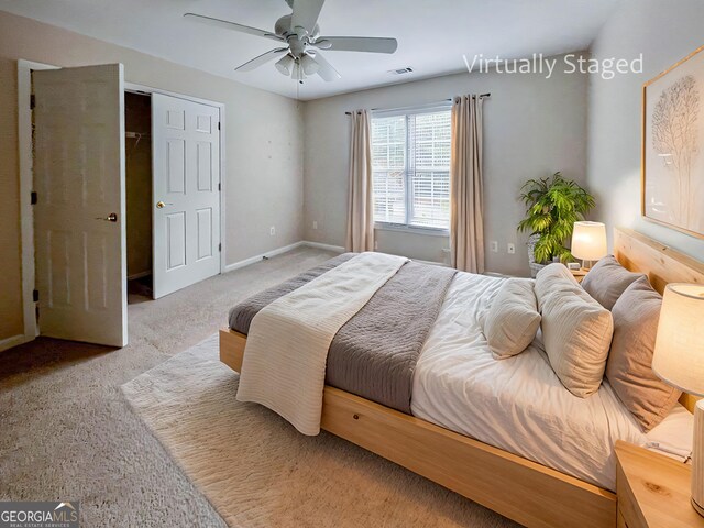 bedroom with ceiling fan, light carpet, and a closet