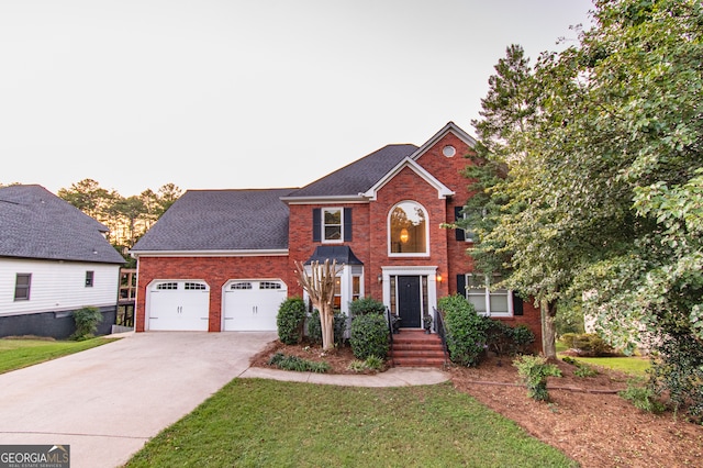 view of front of property with a garage and a front lawn