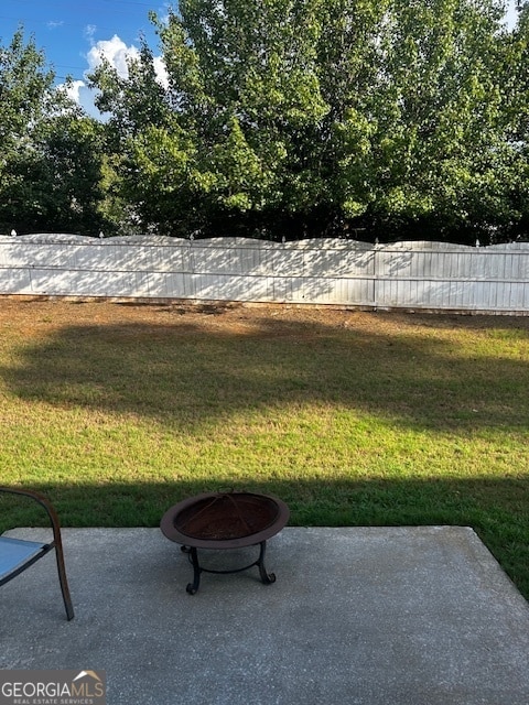 view of yard with a fire pit and a patio area