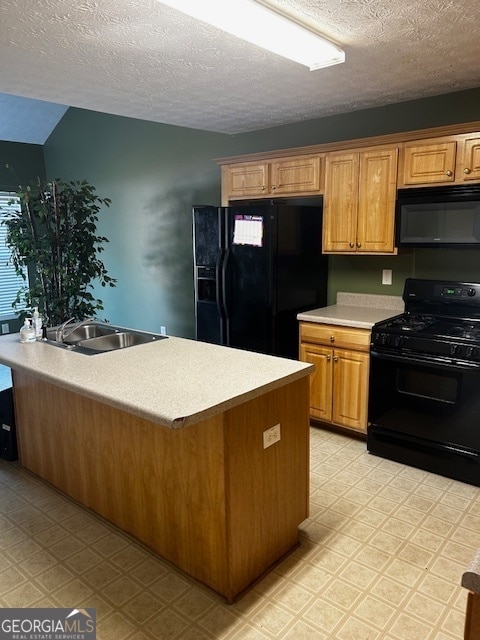 kitchen with light tile patterned flooring, sink, a textured ceiling, and black appliances