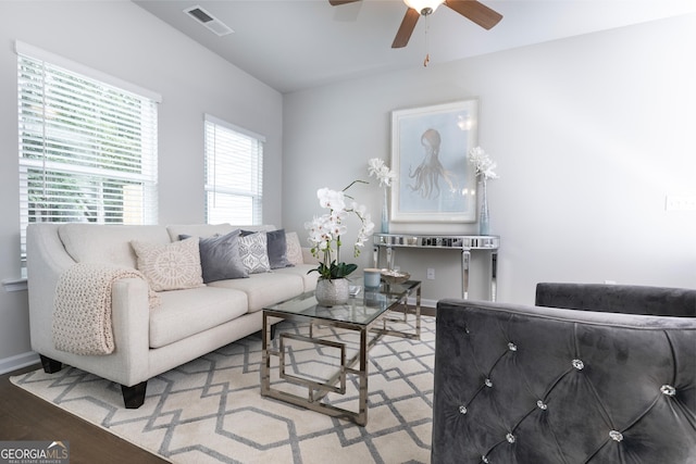 living room featuring light hardwood / wood-style floors and ceiling fan