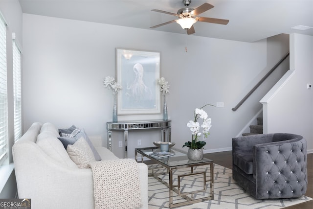 living room featuring light hardwood / wood-style floors and ceiling fan