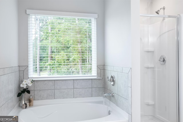 bathroom with independent shower and bath and a wealth of natural light