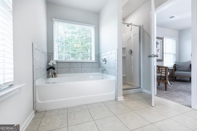 bathroom featuring independent shower and bath and tile patterned floors