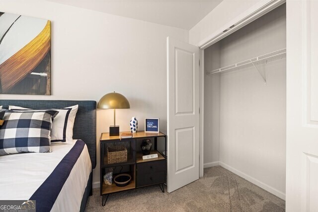 carpeted bedroom featuring a closet