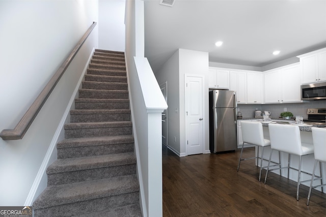 staircase with hardwood / wood-style flooring