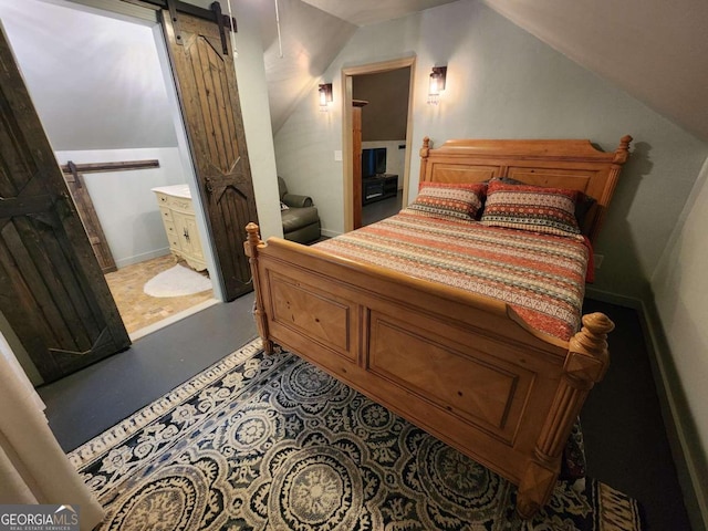870 Morton Dr, Ellijay, GA 30540 - bedroom with a barn door, lofted ceiling, and concrete flooring