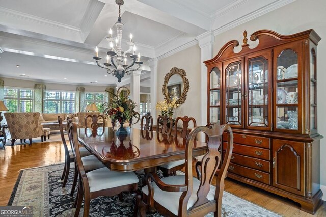 dining space featuring a chandelier, ornamental molding, beamed ceiling, decorative columns, and light hardwood / wood-style floors