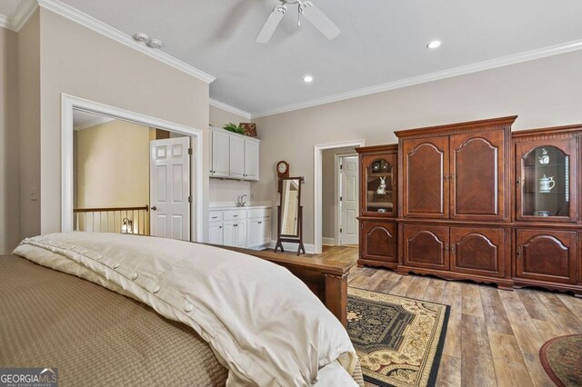 bedroom with ceiling fan, light wood-type flooring, and ornamental molding