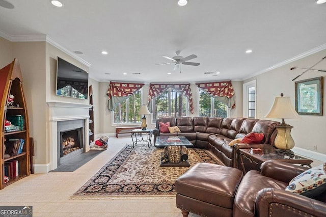 carpeted living room featuring ornamental molding and ceiling fan