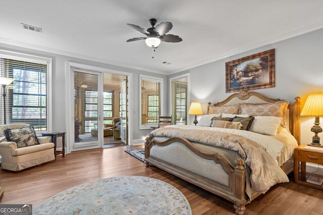 bedroom with multiple windows, access to outside, ceiling fan, and wood-type flooring