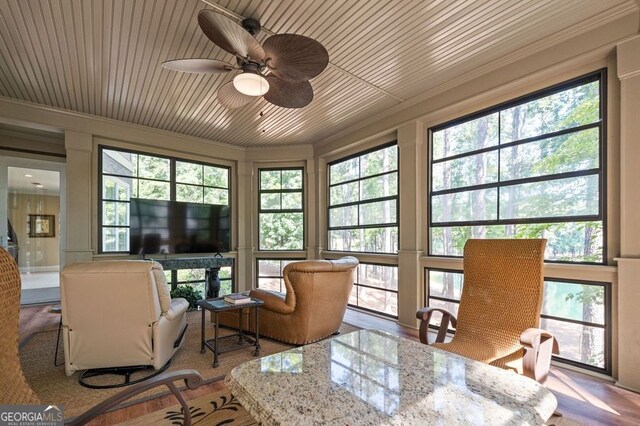 sunroom with ceiling fan and plenty of natural light