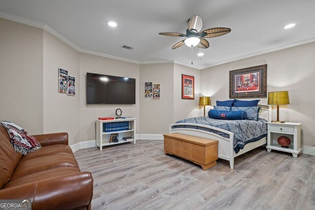 bedroom with ornamental molding, hardwood / wood-style flooring, and ceiling fan