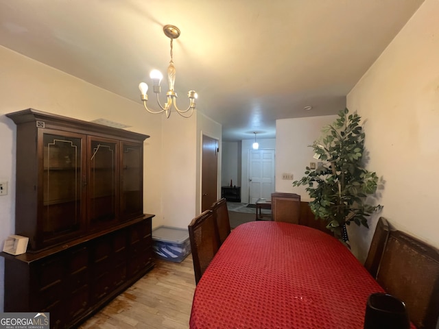 dining room featuring light wood-type flooring and a notable chandelier