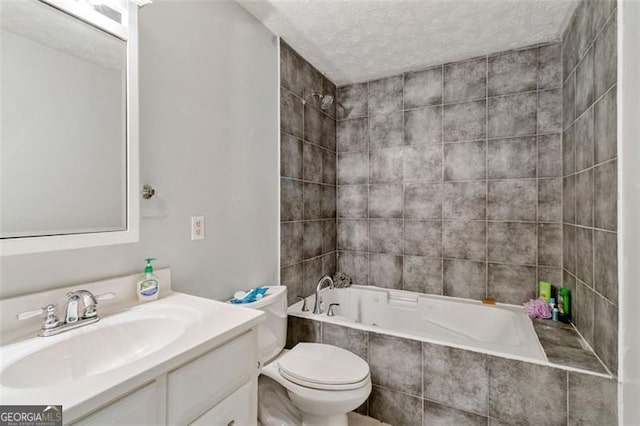 full bath with tiled shower / bath combo, vanity, toilet, and a textured ceiling