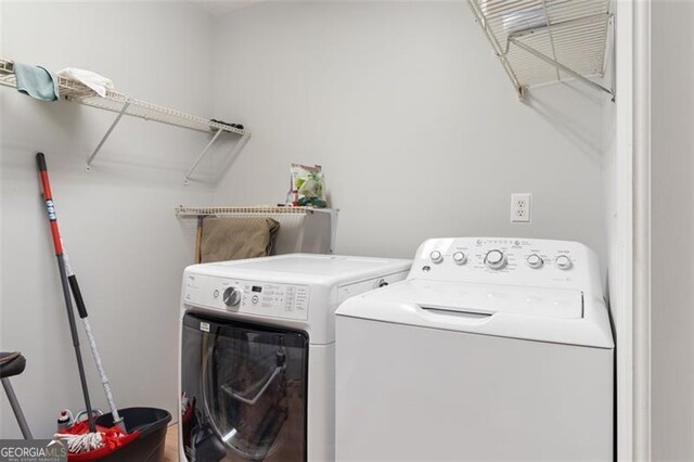 laundry area with laundry area and washer and clothes dryer