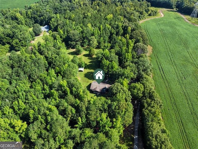 aerial view featuring a rural view and a wooded view