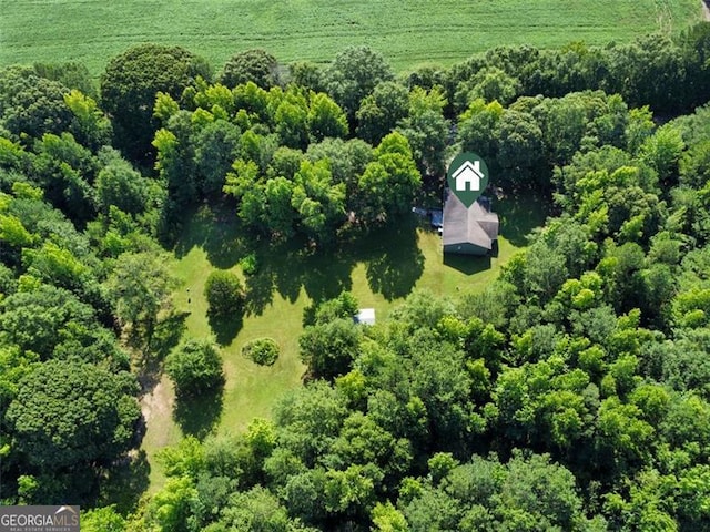 bird's eye view featuring a wooded view and a rural view