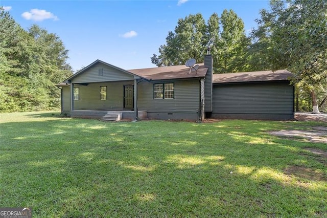 view of front of property with crawl space, a chimney, and a front yard