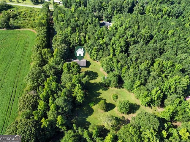 aerial view featuring a rural view and a wooded view