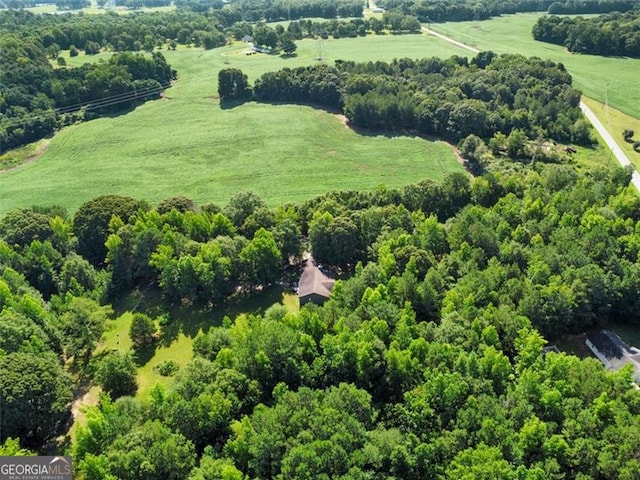 birds eye view of property with a forest view and a rural view