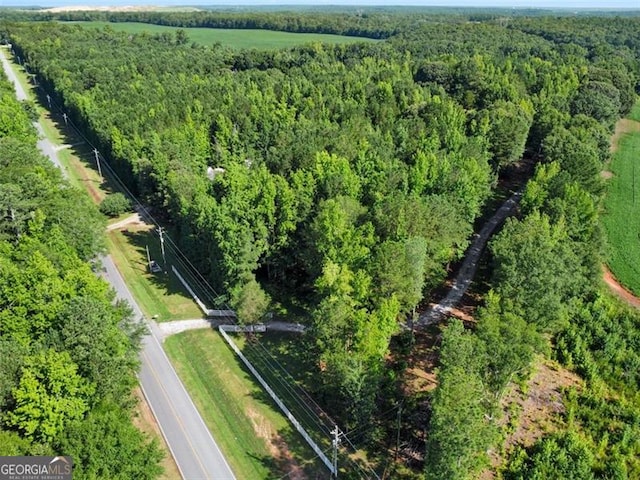 bird's eye view featuring a wooded view