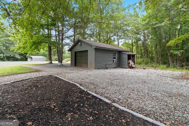 detached garage featuring driveway