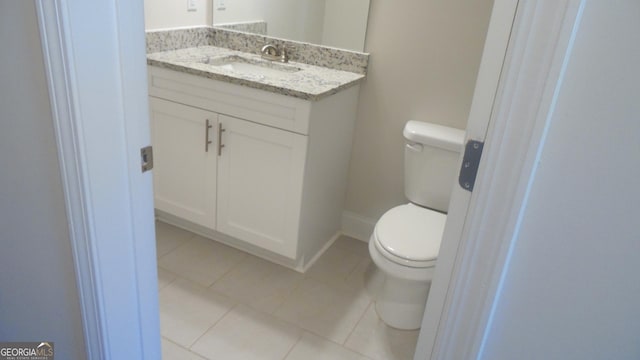 bathroom with vanity, tile patterned floors, and toilet