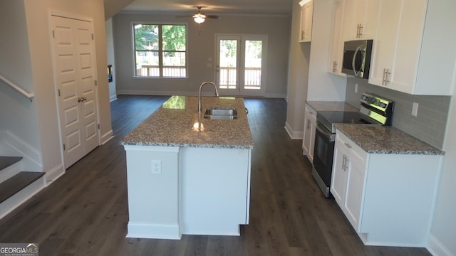 kitchen featuring dark wood-type flooring, sink, white cabinetry, appliances with stainless steel finishes, and light stone countertops