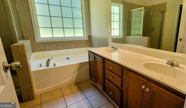 bathroom with tile patterned flooring, vanity, and separate shower and tub