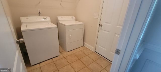 clothes washing area with light tile patterned floors and washing machine and clothes dryer