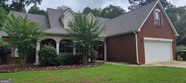 view of front of property with a garage and a front lawn