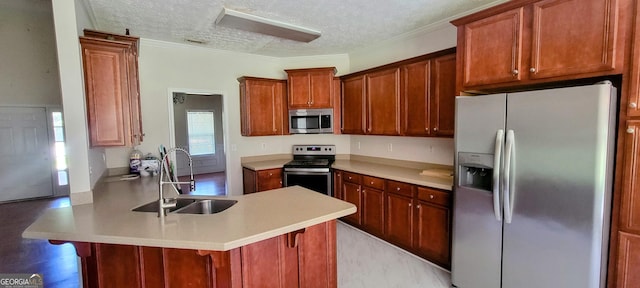 kitchen featuring sink, a kitchen breakfast bar, a textured ceiling, appliances with stainless steel finishes, and ornamental molding