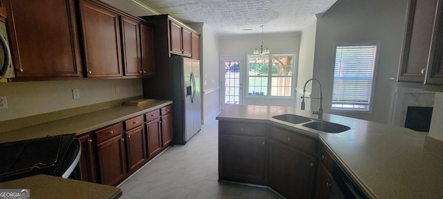 kitchen featuring stainless steel refrigerator with ice dispenser, a textured ceiling, sink, an inviting chandelier, and hanging light fixtures