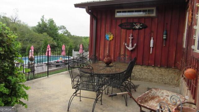 2296 Athens Rd, Royston, GA 30662 - exterior space with outdoor dining area, fence, and a fenced in pool