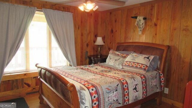 bedroom with wooden walls