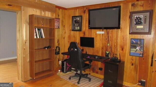 office with wooden walls and hardwood / wood-style floors