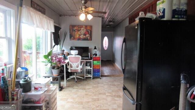 kitchen featuring black fridge and ceiling fan