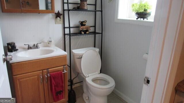2296 Athens Rd, Royston, GA 30662 - half bath featuring toilet, vanity, and baseboards