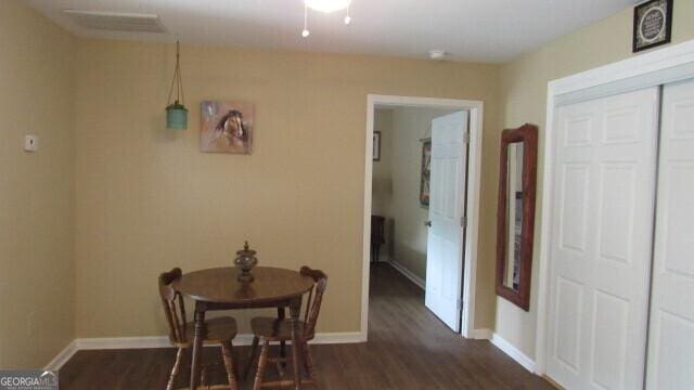 dining space featuring dark wood-type flooring