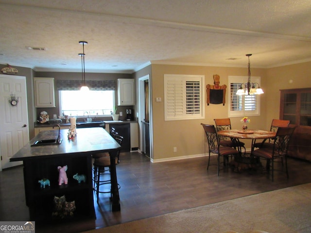 dining room with ornamental molding, dark hardwood / wood-style floors, and sink