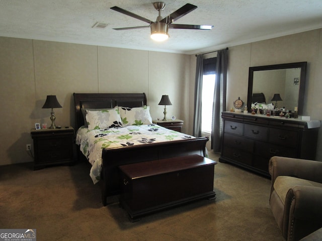 bedroom featuring ceiling fan, crown molding, a textured ceiling, and dark carpet