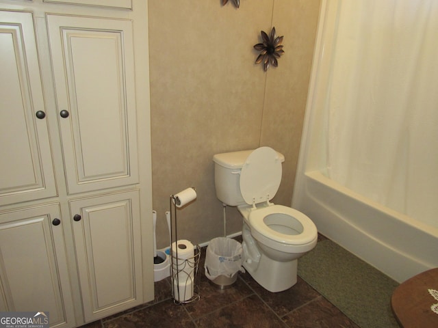 bathroom with shower / tub combo and toilet