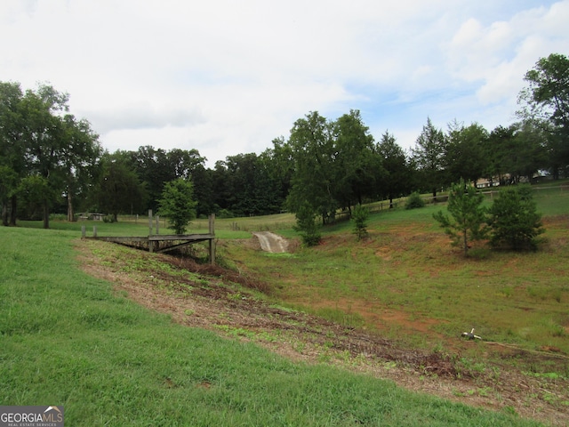 exterior space featuring a rural view and a lawn