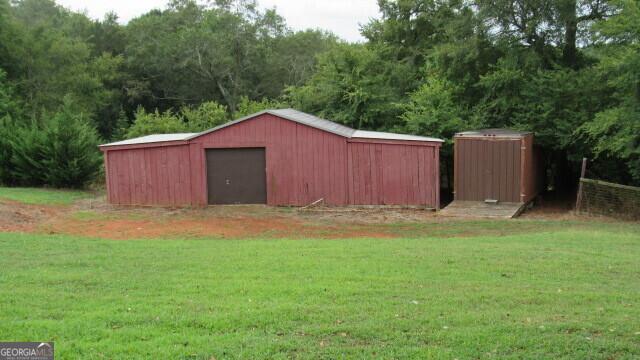 view of outdoor structure with a lawn